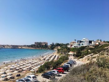 Panoramic view of sea and buildings against clear blue sky