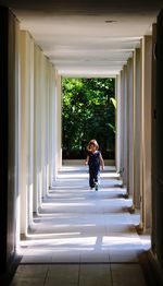 Full length of woman standing by railing