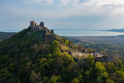 Aerial view about castle of szigliget with lake balaton at the background. spring landscape.