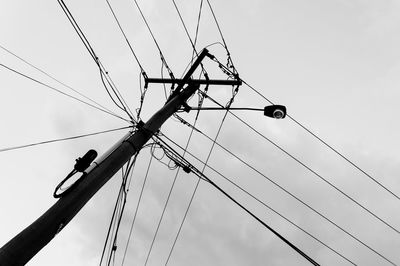 Low angle view of street light against cloudy sky