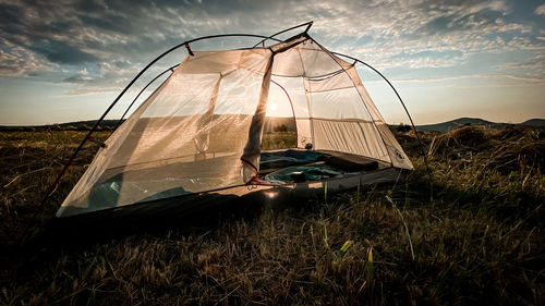 Built structure on land against sky during sunset