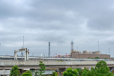 View of factory against cloudy sky