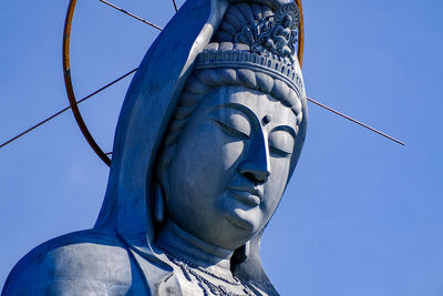 Low angle view of statue against clear blue sky