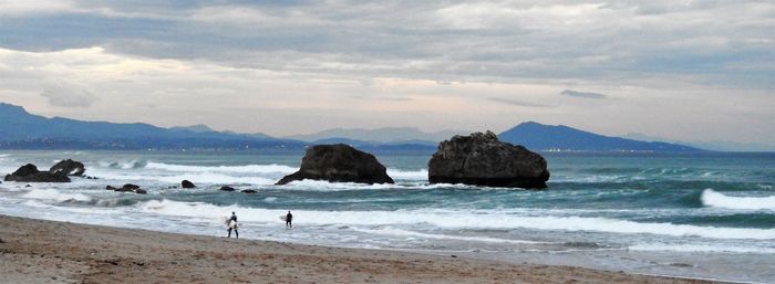 Scenic view of sea against cloudy sky