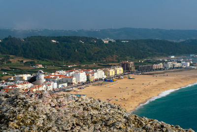 Scenic view of beach and buildings against sky