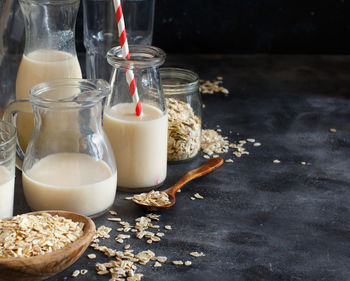 High angle view of oat flake with milk against black background