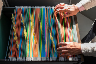 Close-up of hand holding multi colored umbrella