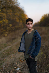 Portrait of young man standing on land