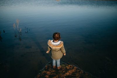 Rear view of boy standing on beach