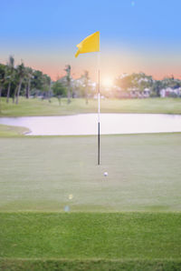 Scenic view of golf course against sky