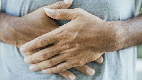 Close-up of man holding hands