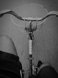 Low section of man with bicycle on street