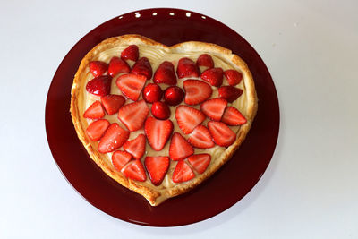 High angle view of strawberries in bowl against white background