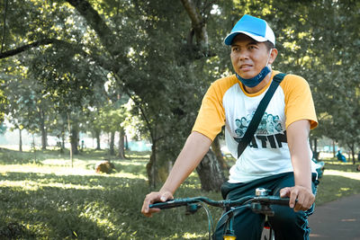 Full length of man riding bicycle