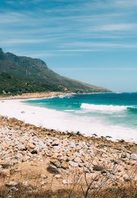 Scenic view of beach against blue sky