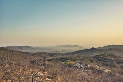 Scenic view of field against sky during sunset