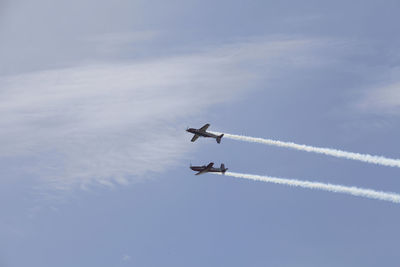 Low angle view of airplane flying against sky