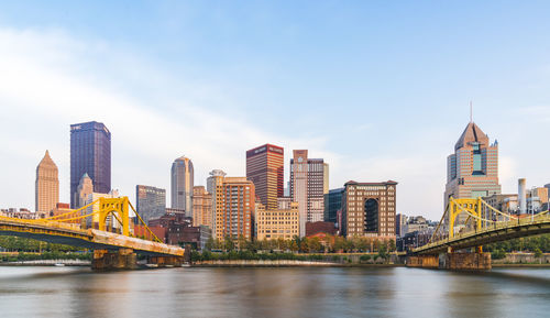 Bridge over river with buildings in background