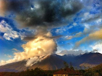 Scenic view of mountains against cloudy sky