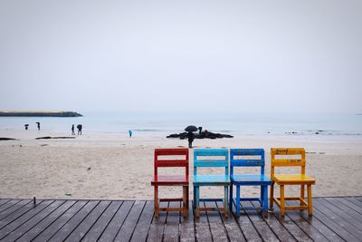 Multi colored chairs on boardwalk