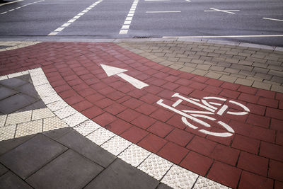 High angle view of arrow symbol with bicycle lane on road