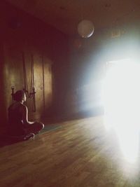 Blurred motion of woman in illuminated room