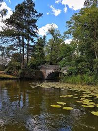 Arch bridge over river against sky