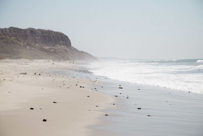 Scenic view of beach against clear sky