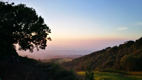 Scenic view of landscape against sky at sunset