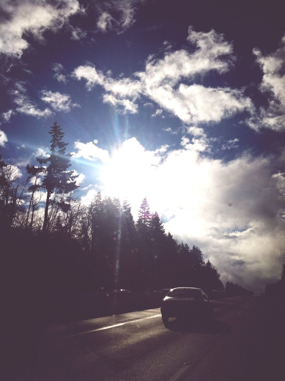 transportation, sun, car, land vehicle, sky, sunbeam, sunlight, mode of transport, road, lens flare, tree, cloud - sky, street, silhouette, nature, cloud, sunny, outdoors, day, on the move