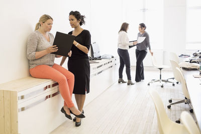 Businesswomen discussing in creative office