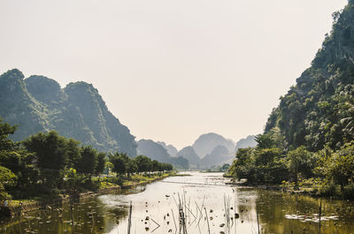 Scenic view of lake and mountains against sky