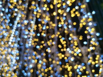 Defocused image of illuminated lights at night, bokeh background