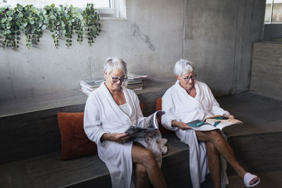 Senior women reading magazine