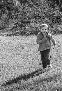 Portrait of girl standing on field