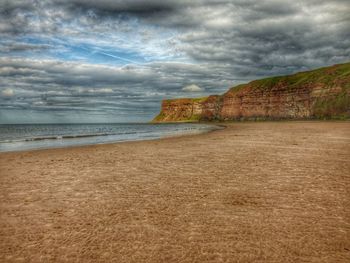 View of beach against cloudy sky