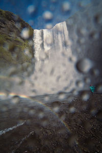 Large waterfall view through drops landscape photo