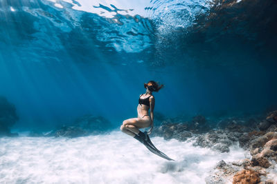 Full length of woman swimming in sea