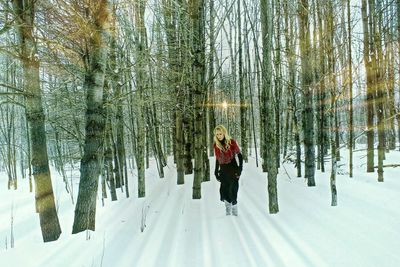 People standing on snow covered forest