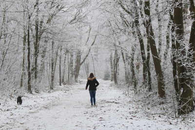 Woman in snow covered forest