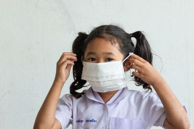 Portrait of girl wearing mask at classroom