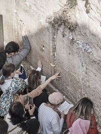 High angle view of people standing by wall
