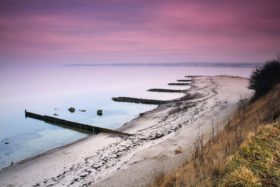 Scenic view of beach against sky during sunset