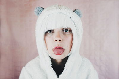 Close-up portrait of woman in costume against pink wall