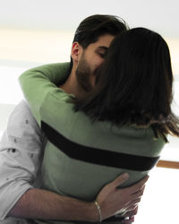 Portrait of young woman sitting at home