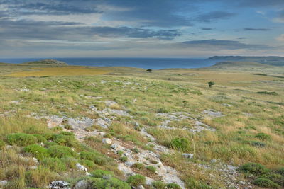 Scenic view of sea and mountains against sky