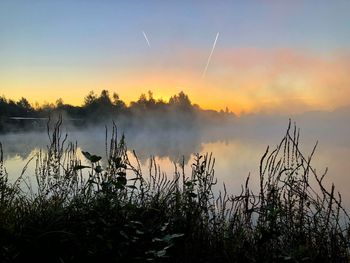 Scenic view of lake against sky during sunset