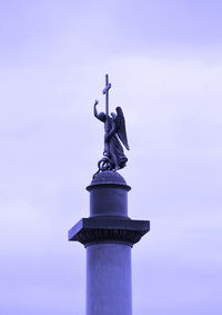 Low angle view of statue against blue sky