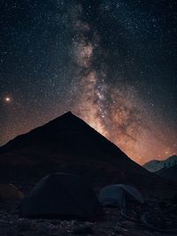 Scenic view of mountains against sky at night