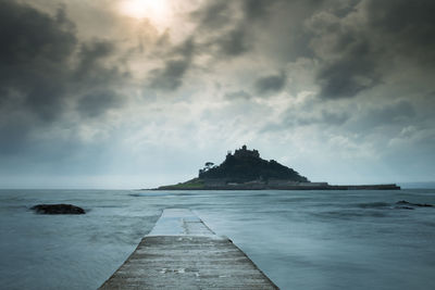 View of calm sea against cloudy sky
